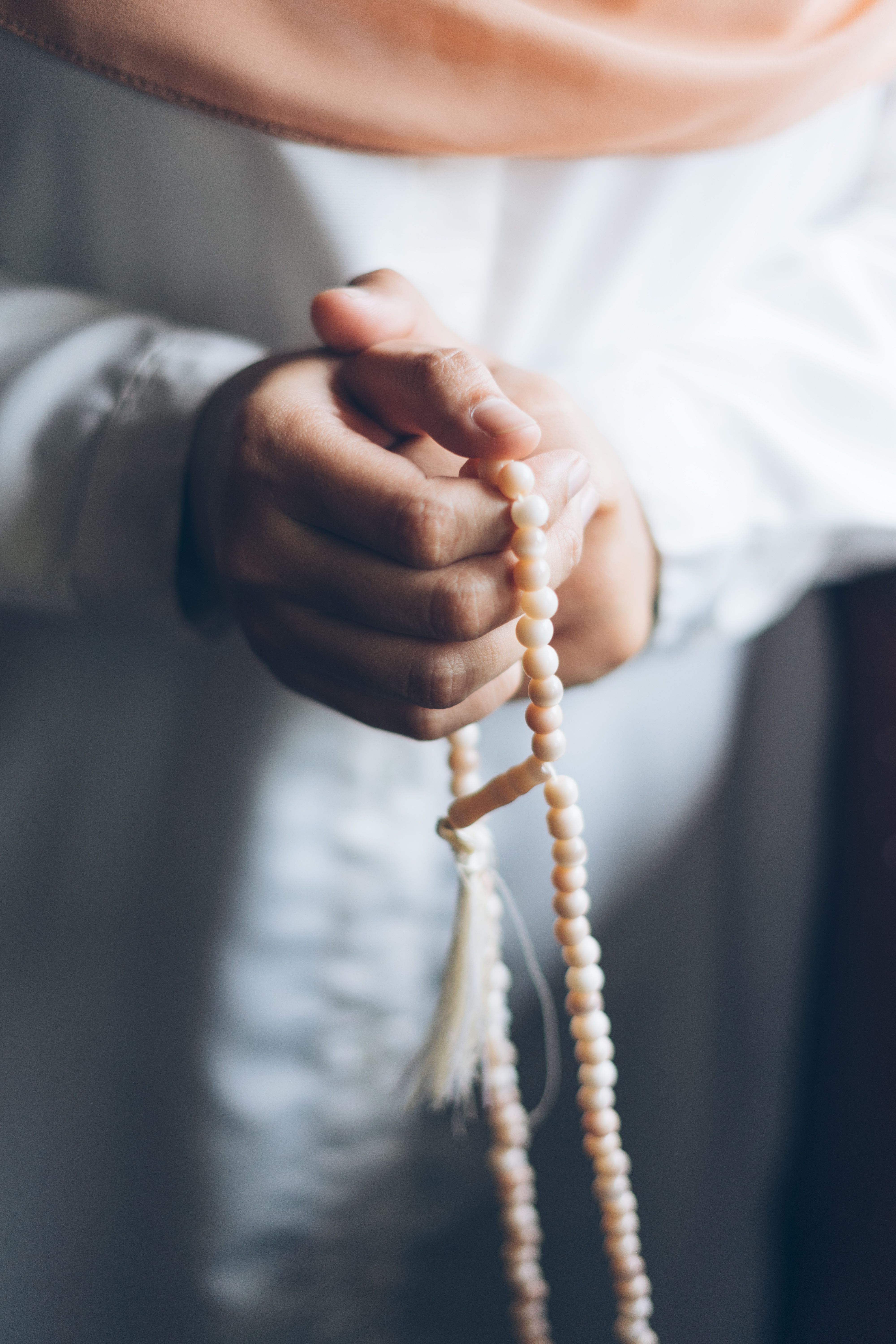 Close-Up of Hands Holding Prayer Beads · Free Stock Photo