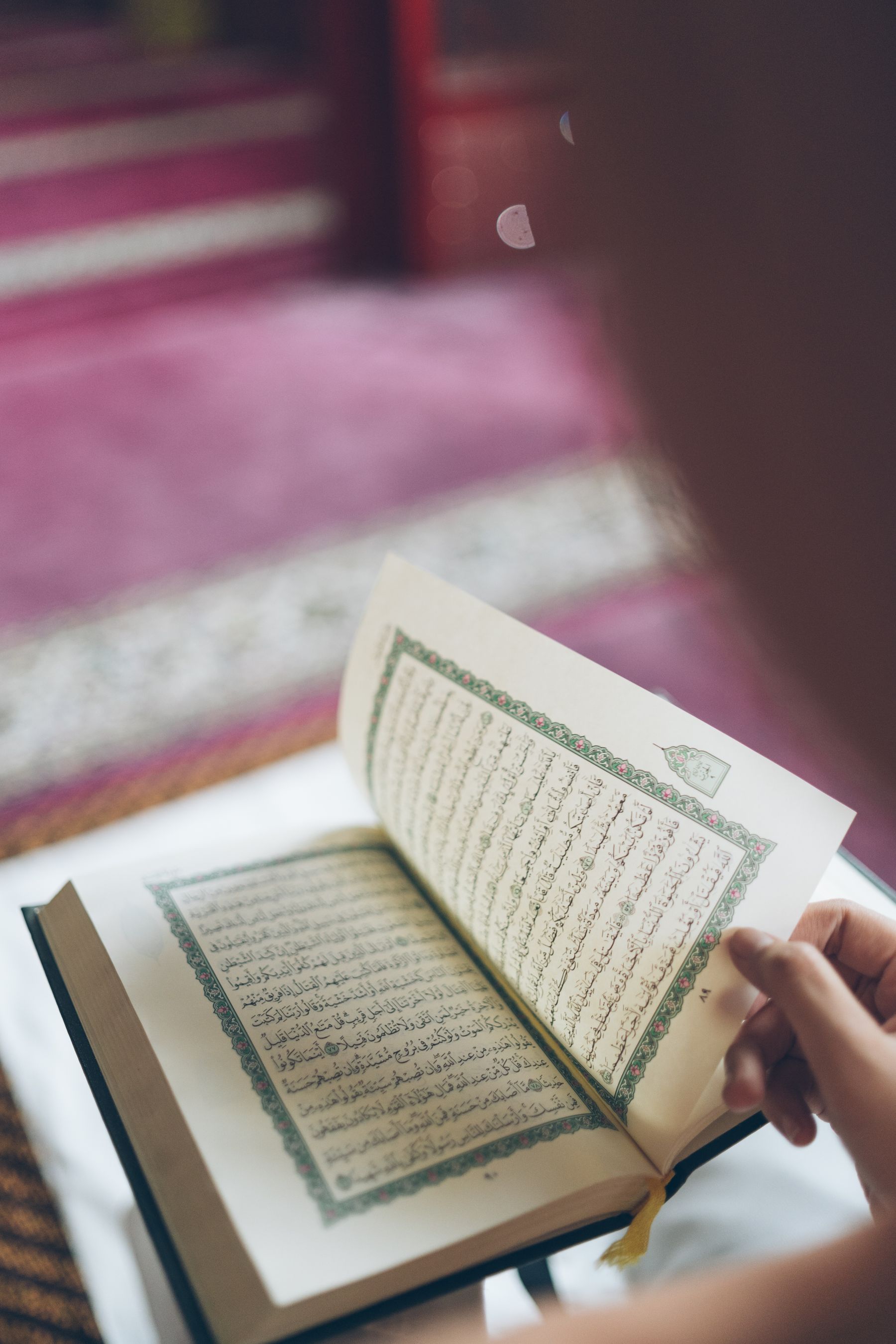 Person reading the Quran in a mosque
