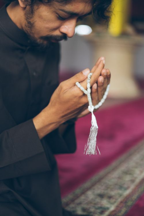 Man Praying with Prayer Beads in Mosque · Free Stock Photo