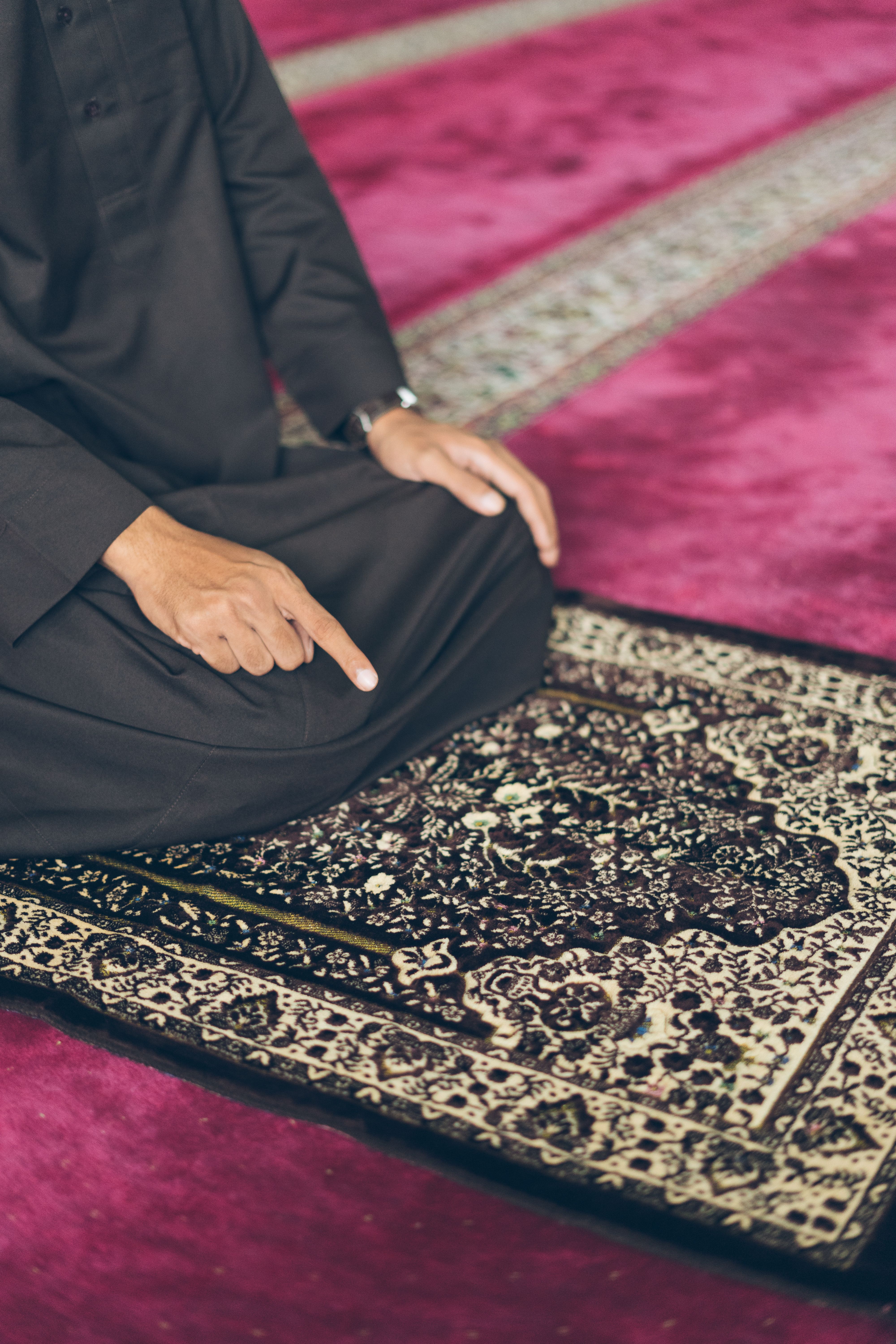 Man in Traditional Attire Praying Indoors · Free Stock Photo