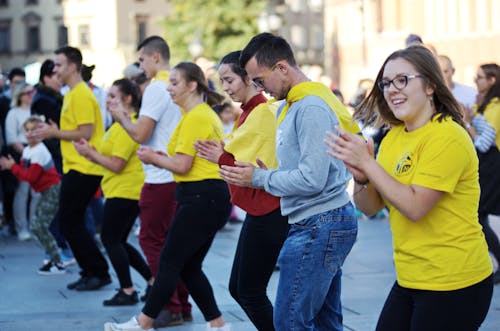 Group of People Wearing Yellow Shirt Dancing