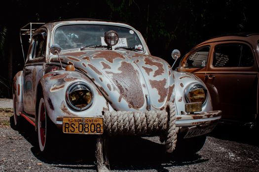 Rustic vintage Volkswagen with Rio de Janeiro plates parked outdoors.