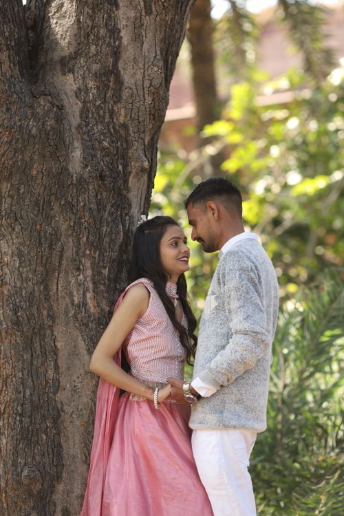 Free A romantic Indian couple shares a heartfelt moment outdoors by a tree, showcasing love and tradition. Stock Photo