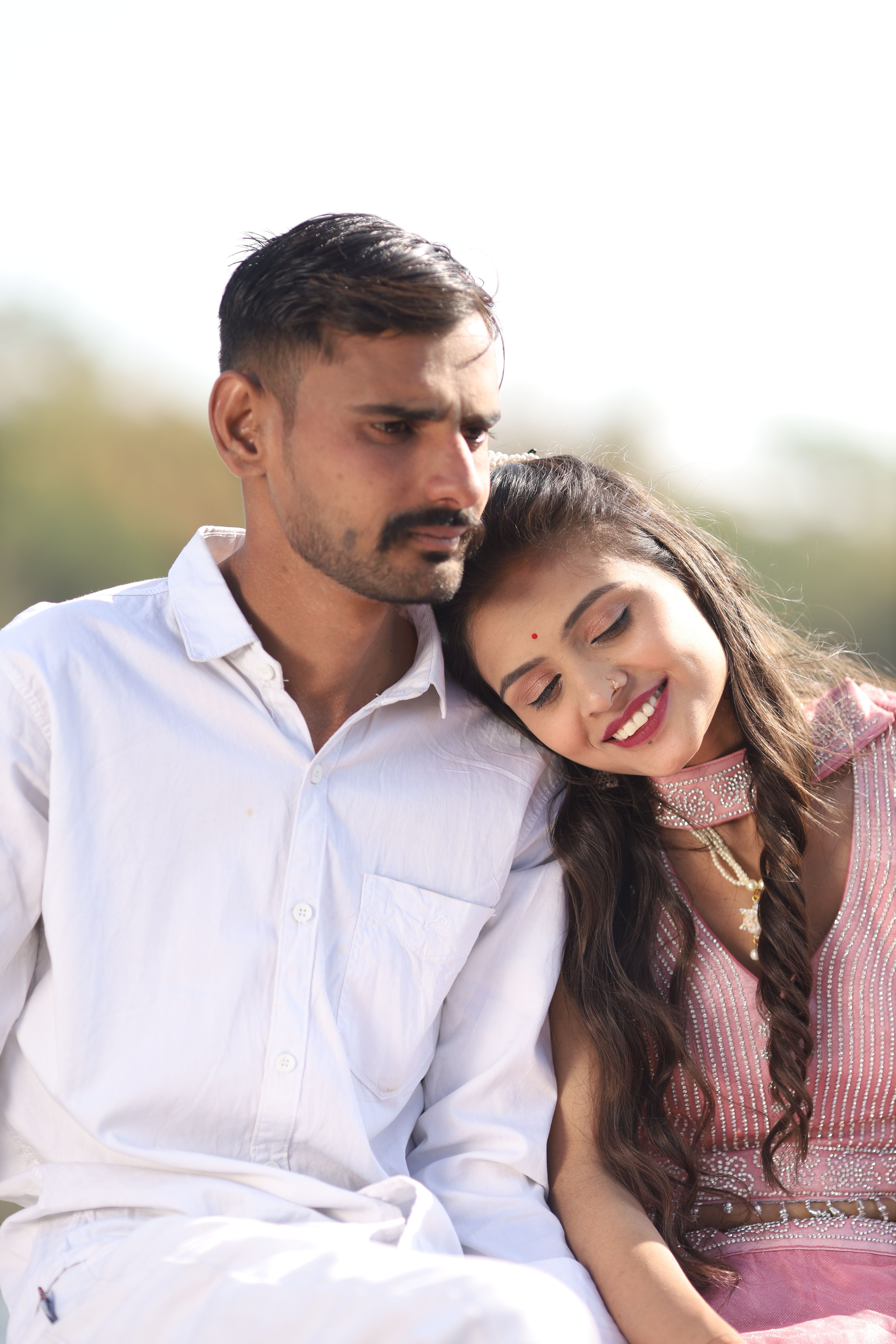 Portrait of a loving Indian couple embracing outdoors, capturing a joyful moment together.