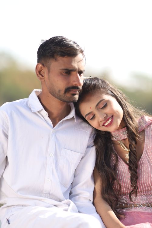 Free Portrait of a loving Indian couple embracing outdoors, capturing a joyful moment together. Stock Photo
