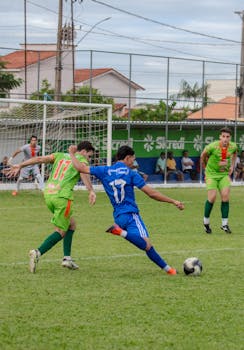 A dynamic moment in a soccer game with players in mid-action on a green field.