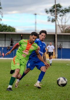 Two soccer players in action during a competitive outdoor match.