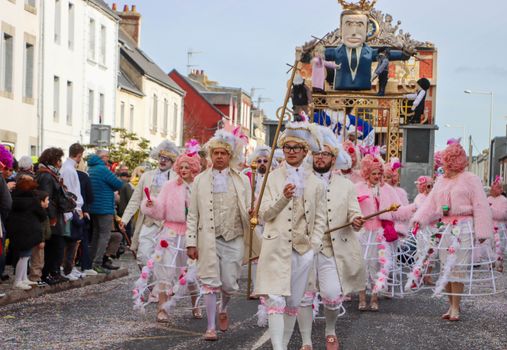Festive carnival parade with costumes and floats in Granville, France.