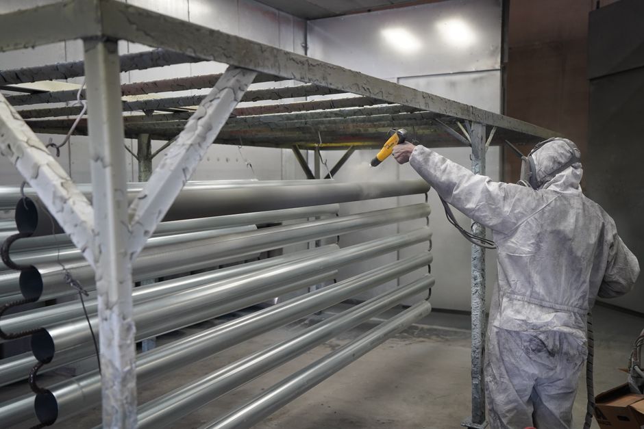 technician applying protective coil coating to outdoor AC unit technician applying protective coil coating to outdoor AC unit