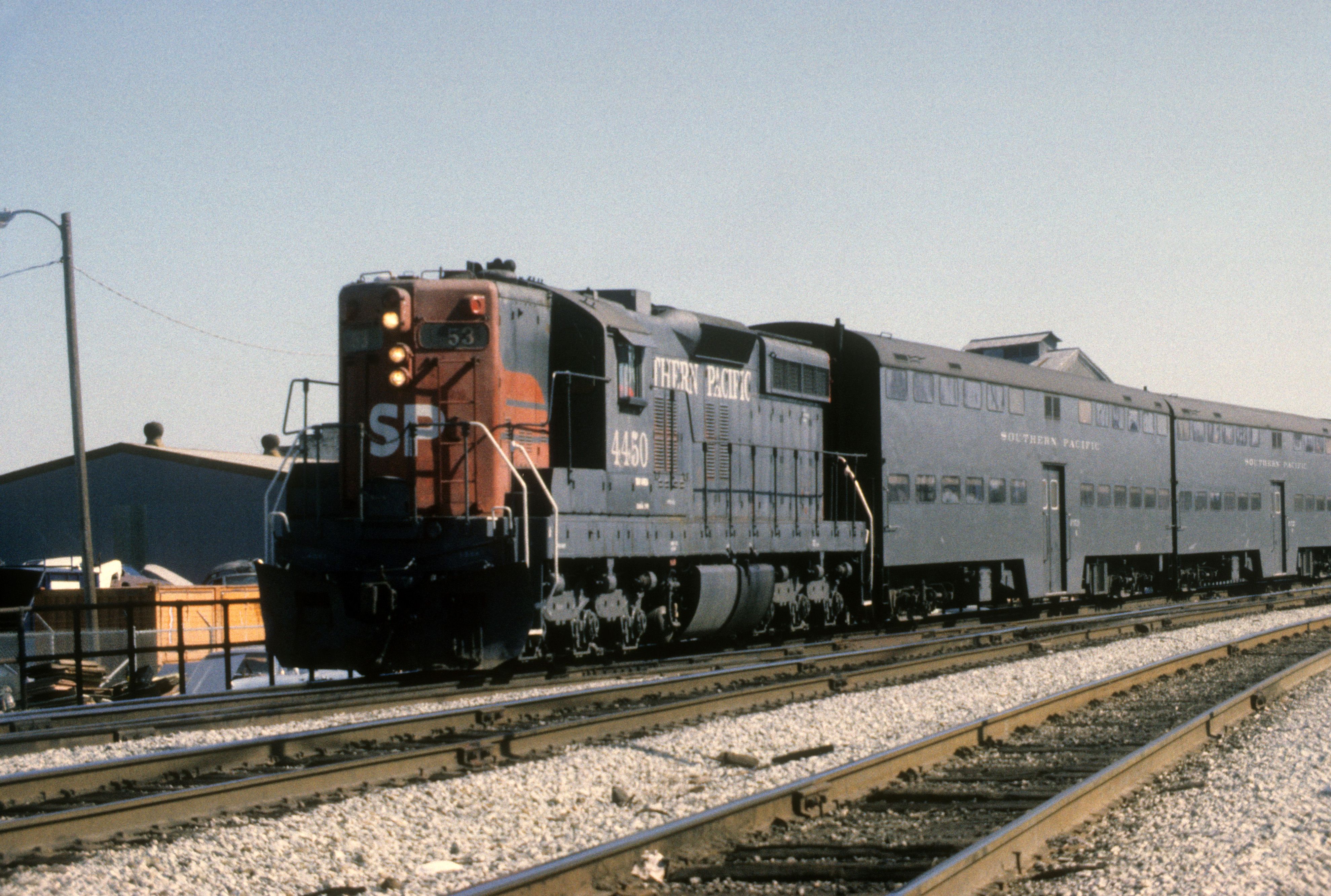 Vintage Southern Pacific train viewed outdoors at a San Jose rail yard on a sunny day.