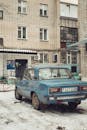 Vintage Car Parked in Snowy Urban Setting