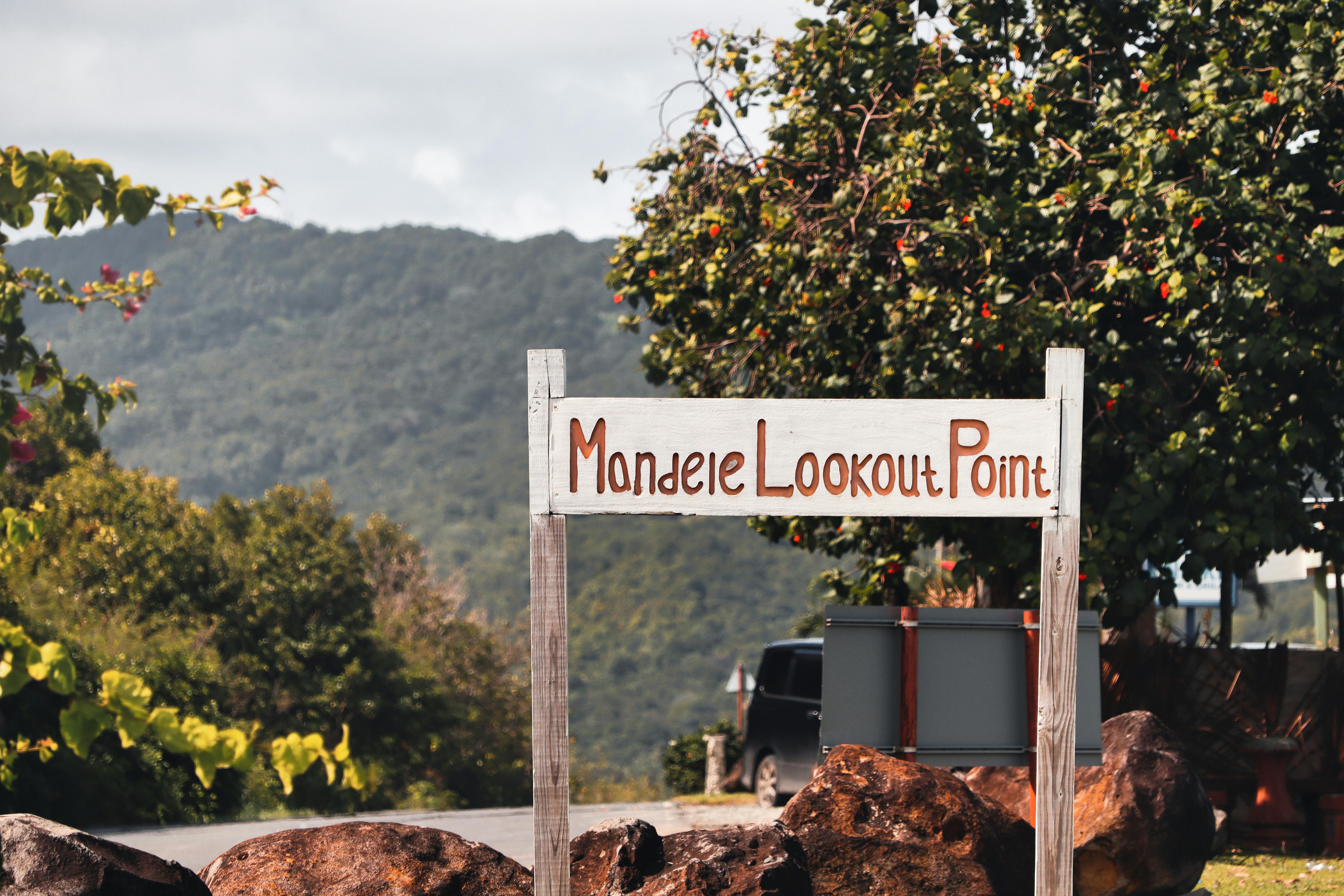 A picturesque sign at Mondele Lookout Point, offering stunning views in Saint Lucia.