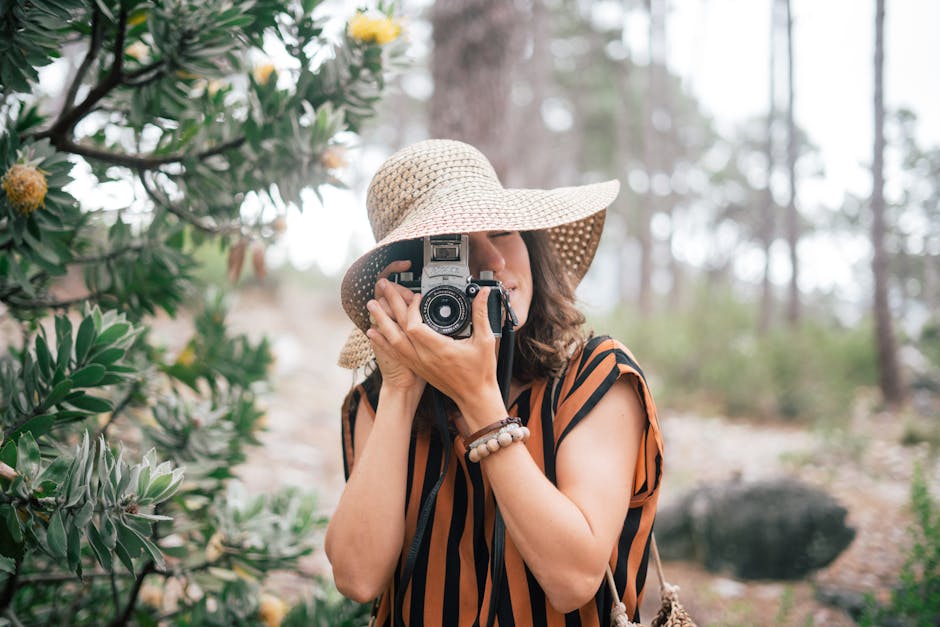 Woman Wearing Brown Sun Hat Holding A Camera