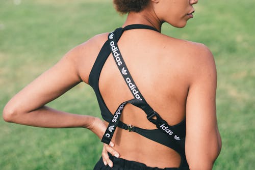 Two Women in Activewear Clothes Standing Back to Back · Free Stock Photo