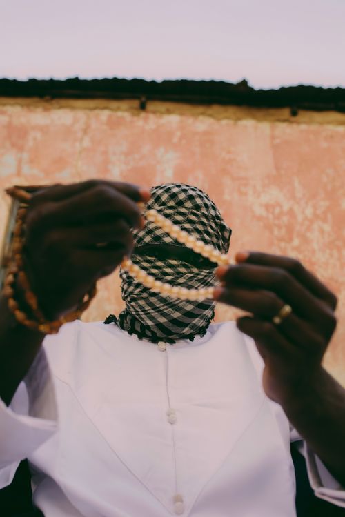 Free Portrait of a person in traditional attire holding jewelry, adding an air of mystery. Stock Photo