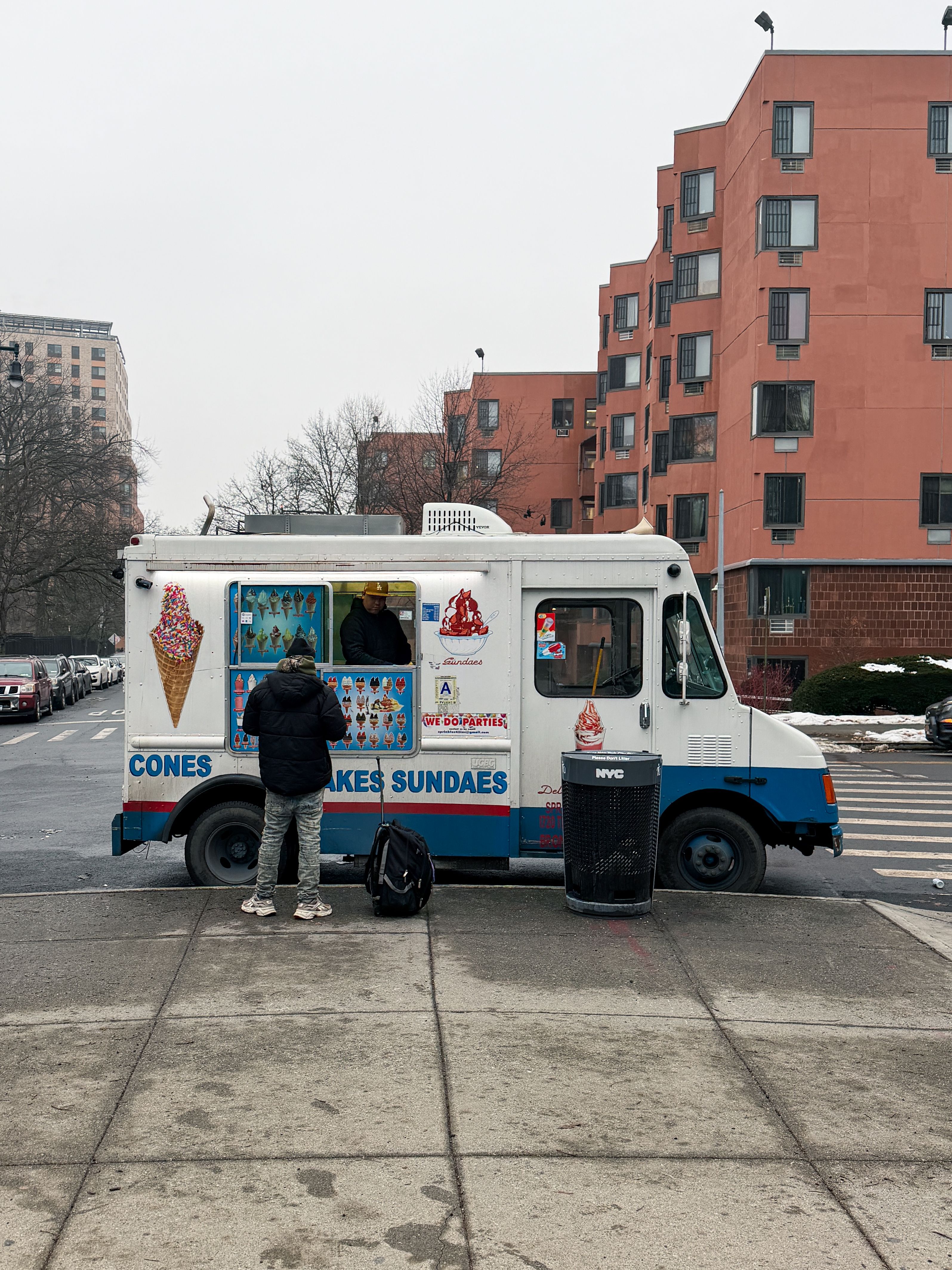 Classic ice cream truck serving on a New York street. Winter setting.