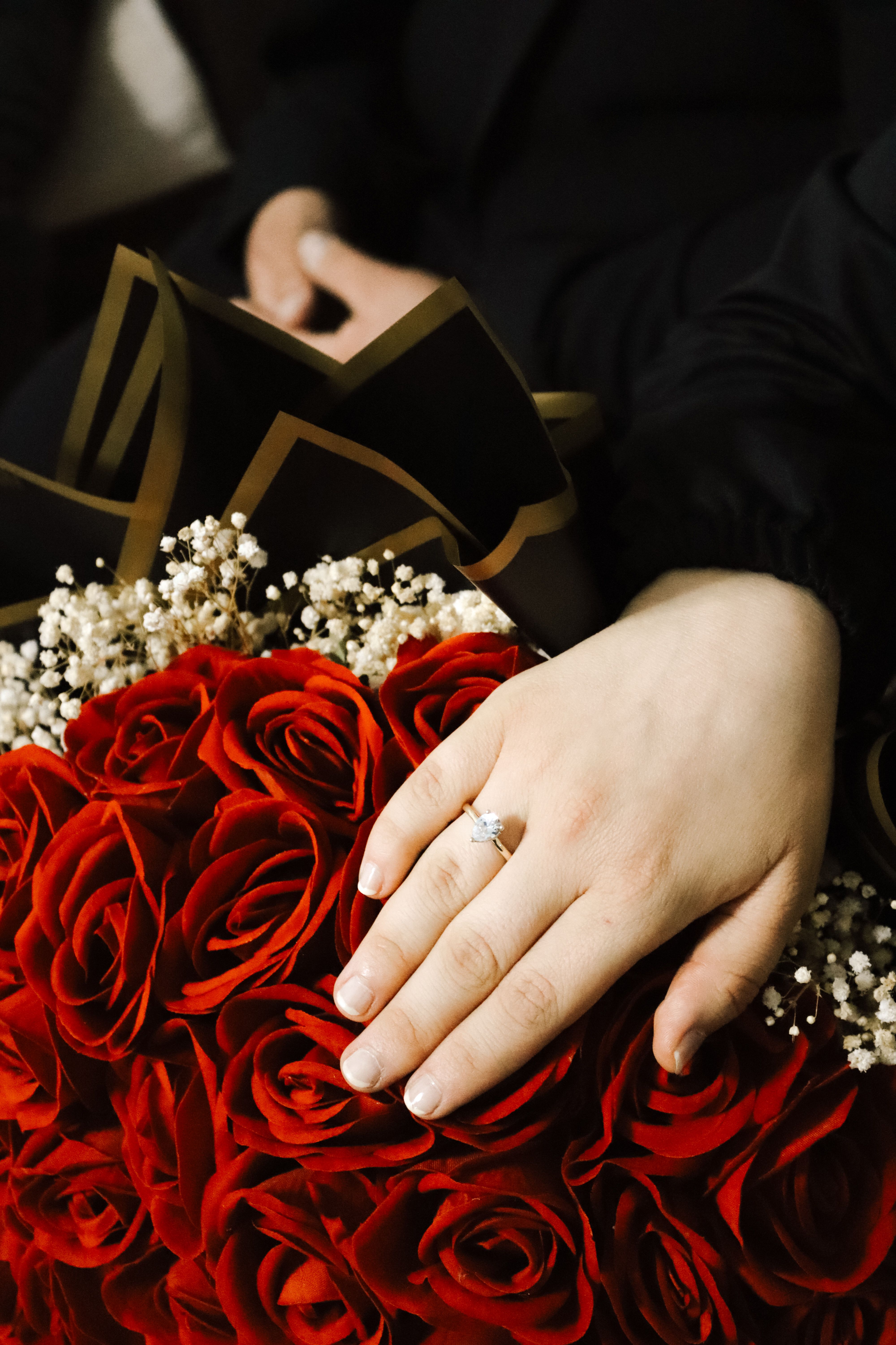 Engagement Ring on Hand with Red Roses · Free Stock Photo