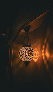 Warmly lit mosaic lamp casting intricate shadows on the wall, creating a cozy ambiance.