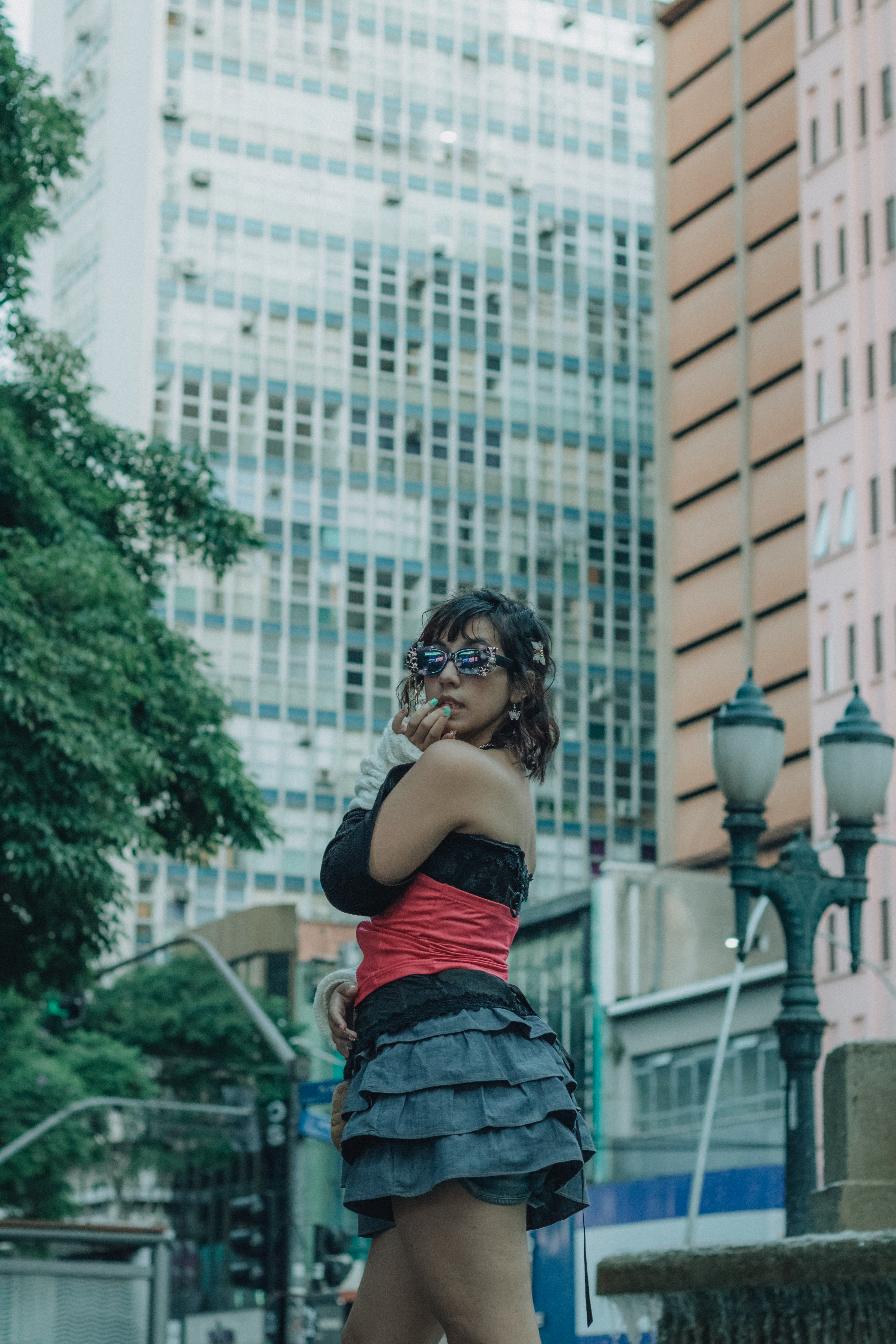 Stylish Woman in Urban Setting with Skyscrapers · Free Stock Photo