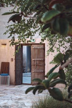 Inviting rustic wooden door in a lush green setting, evoking a sense of adventure.