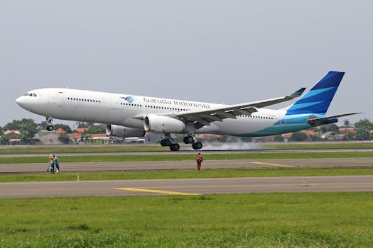 Garuda Indonesia Airbus A340-300 landing on a runway with visible smoke from the tires.