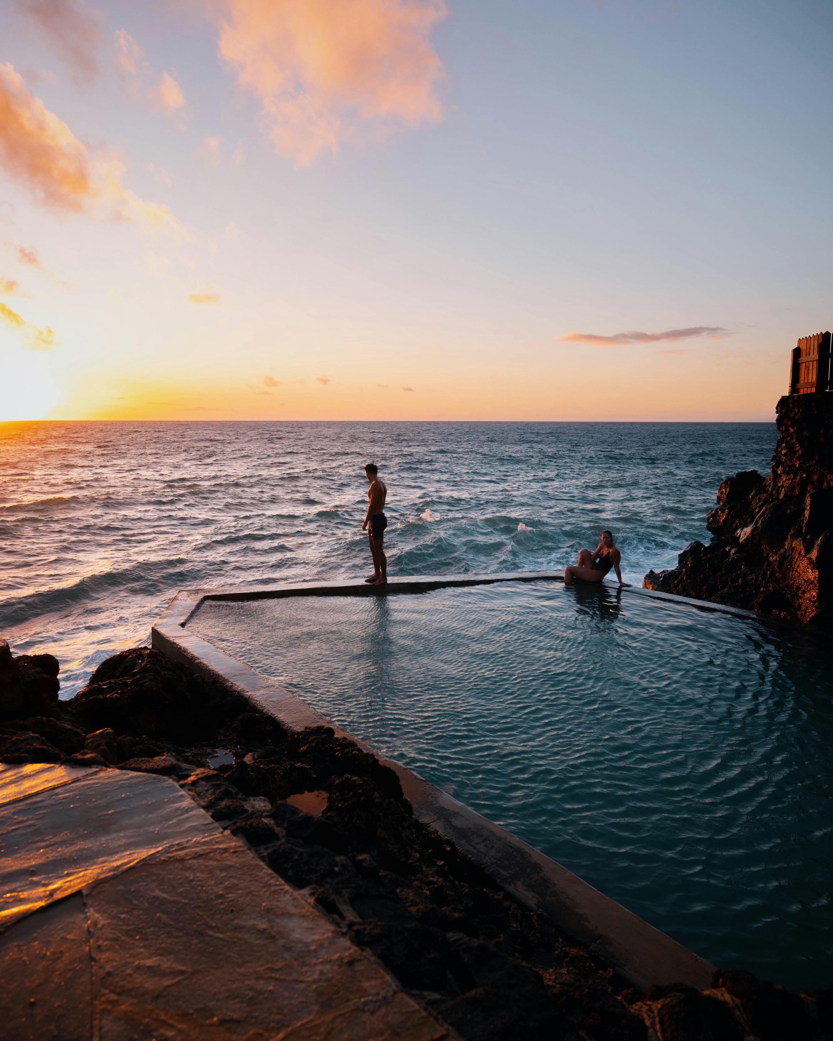 Cliff-edge infinity pool at a luxury Bukit Peninsula resort at sunset in Uluwatu, Bali
