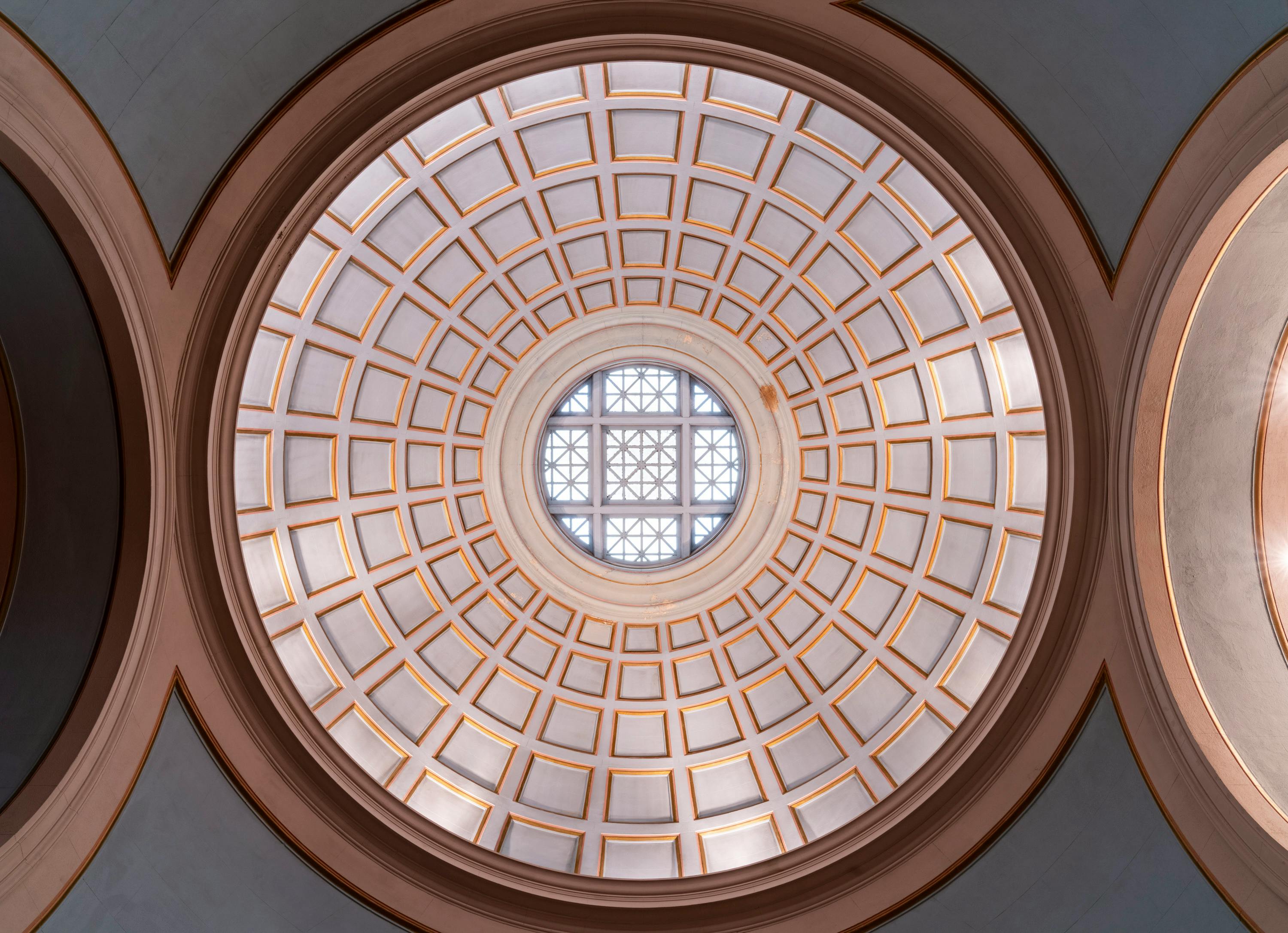 Elegant dome ceiling featuring a geometric pattern with natural lighting.