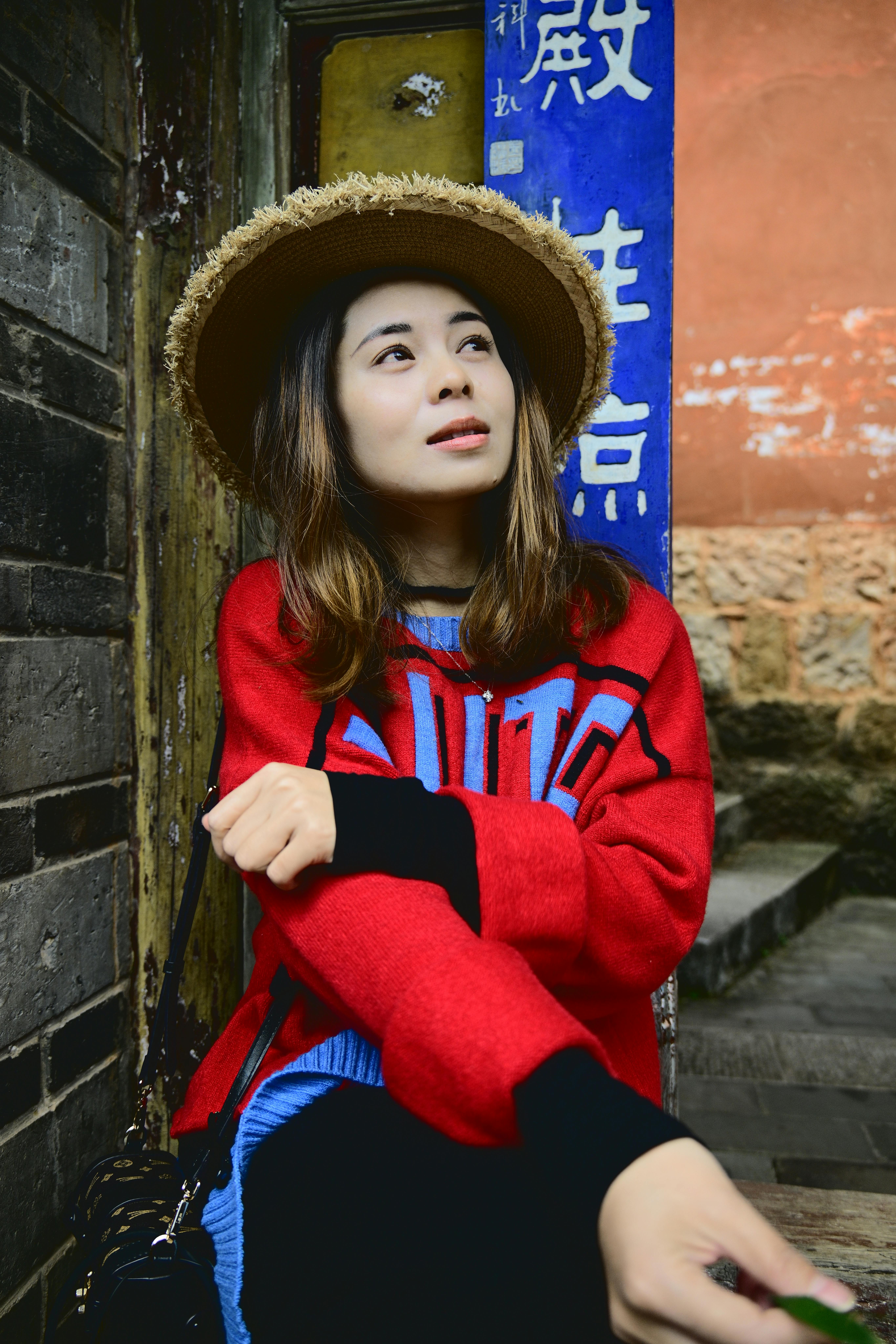 Young Woman in Vibrant Red Sweater Outdoors