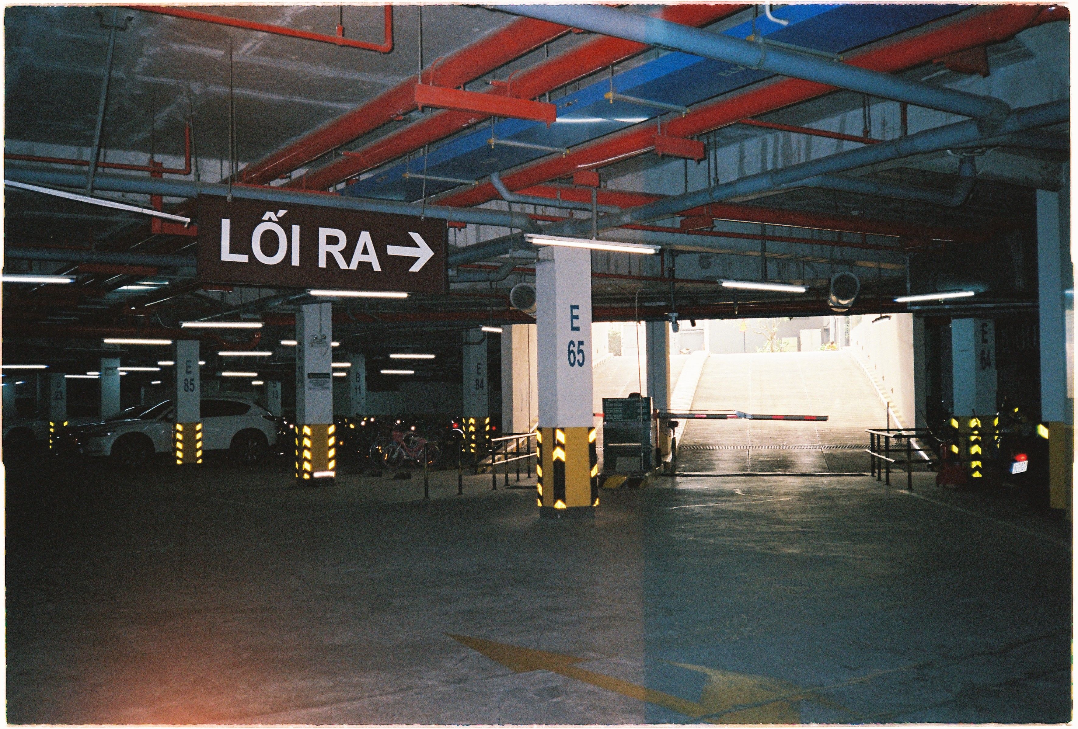 Parking garage exit with directional sign in Ho Chi Minh City, Vietnam.