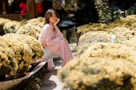 Young Woman in Kimono Amidst Chrysanthemums
