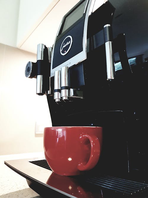 Black Coffeemaker With Red Ceramic Teacup