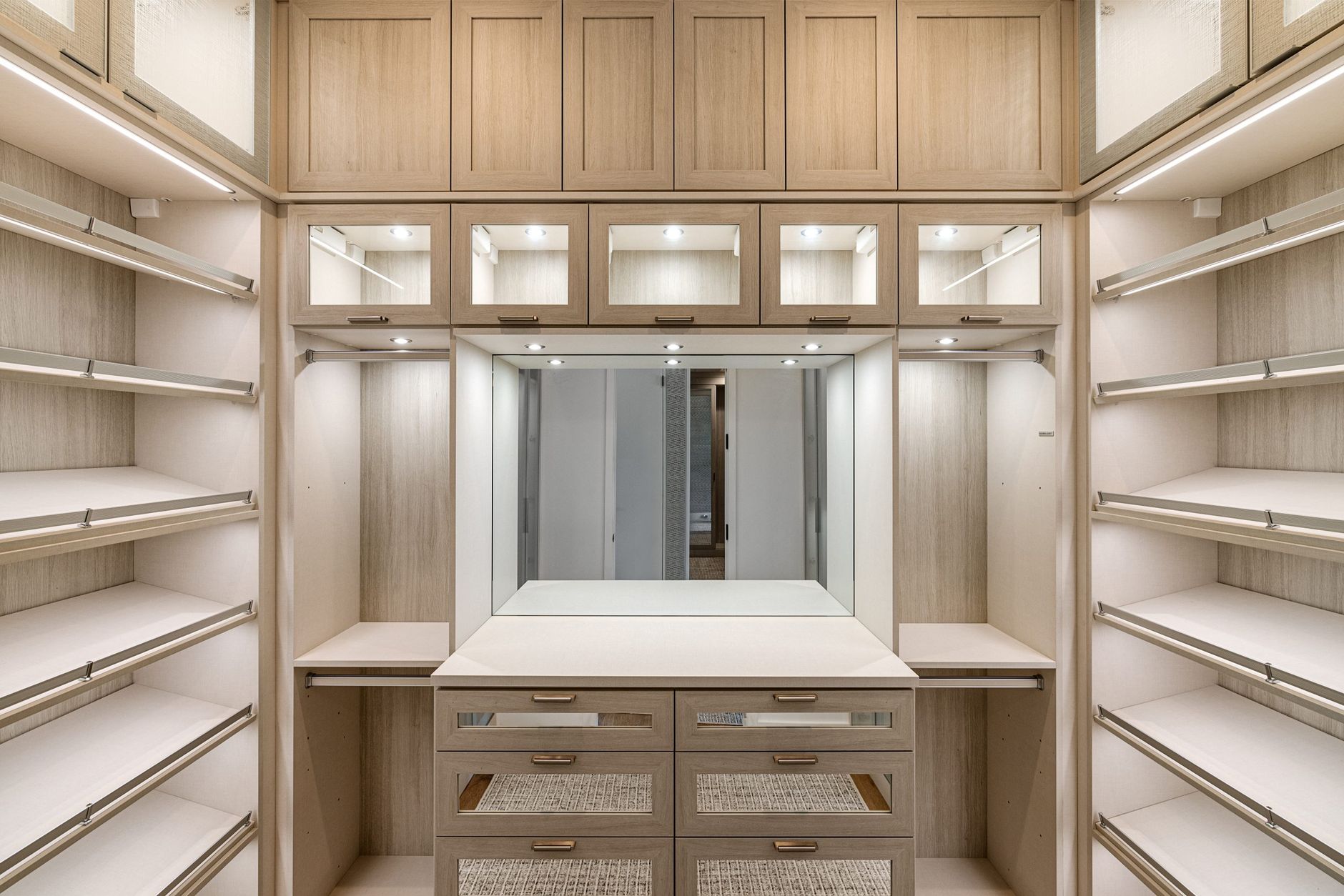 designer closet makeover for modern homes Spacious walk-in closet with wooden cabinets and ample lighting.