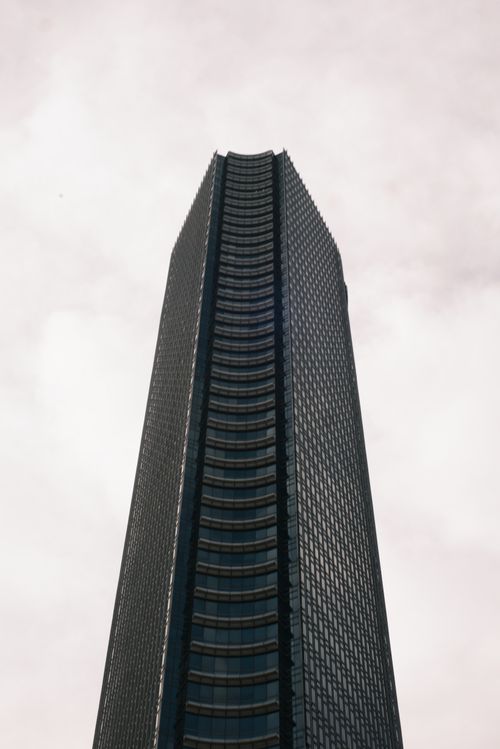 Free Impressive tall skyscraper with a sleek glass facade reaching into the sky, showcasing modern architectural design. Stock Photo