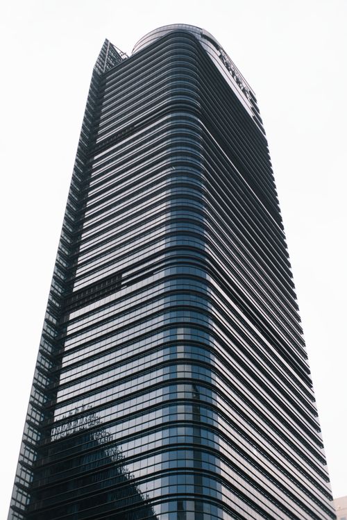 Free Tall, modern skyscraper with glass facade and steel structure against the sky. Stock Photo