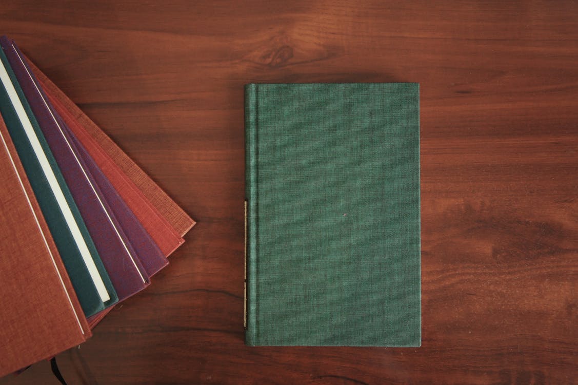 Free Books on Wooden Surface Stock Photo