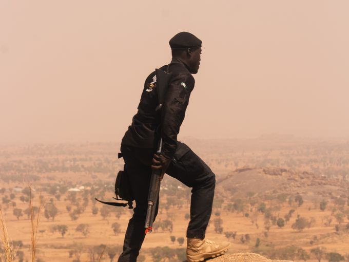 Security officer on high ground overlooking a remote project site