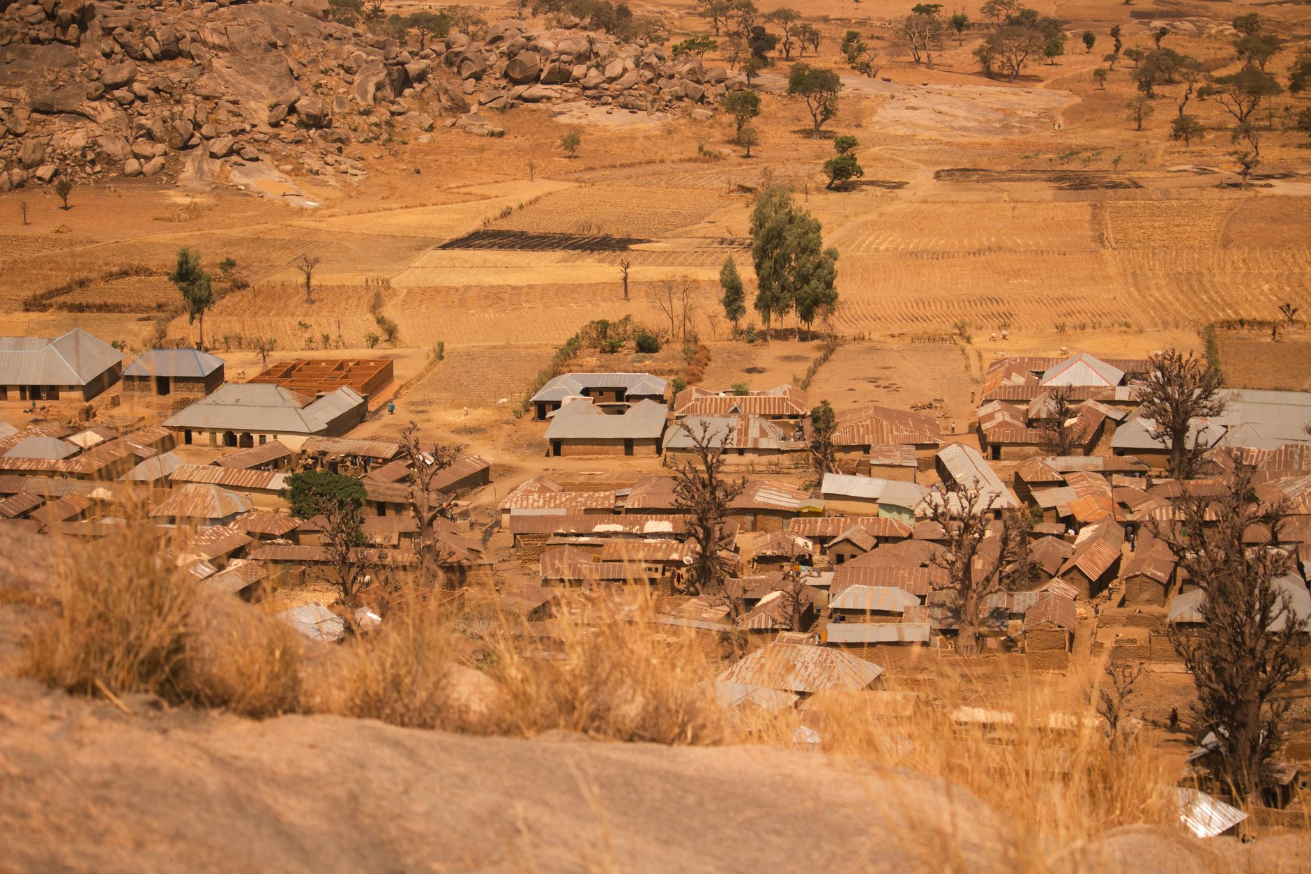 Scenic aerial view of a rural village nestled in the arid landscape of Kaduna, Nigeria.