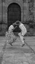 Traditional Dance Couple Jump Near Old Doorway