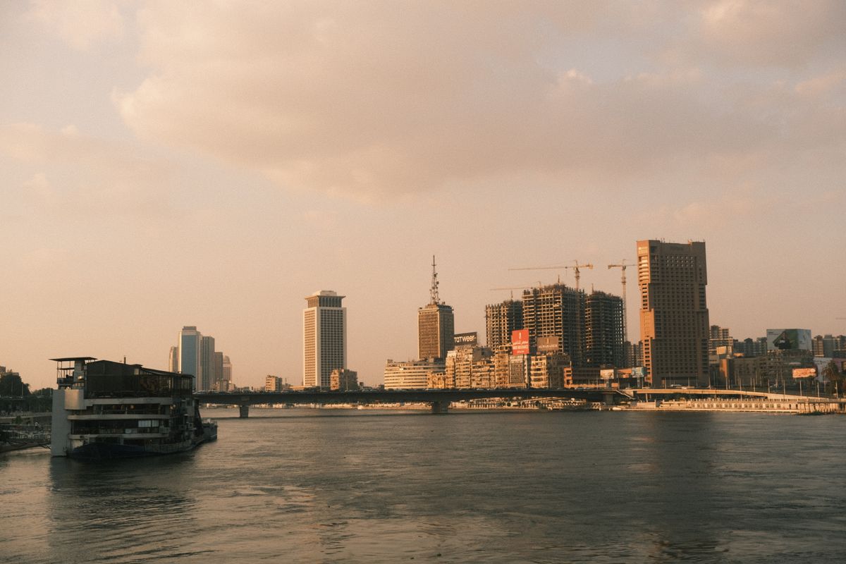 A Nile dinner cruise boat docked against Cairo's skyline at dusk, Egypt