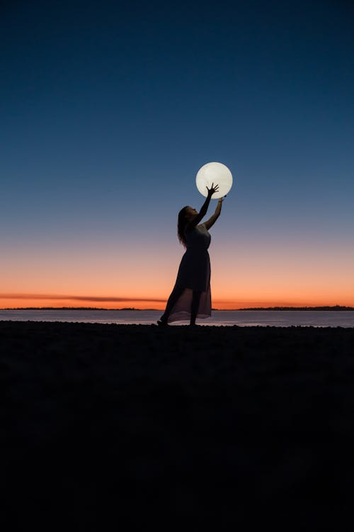 Free Woman Holding a Moon Stock Photo