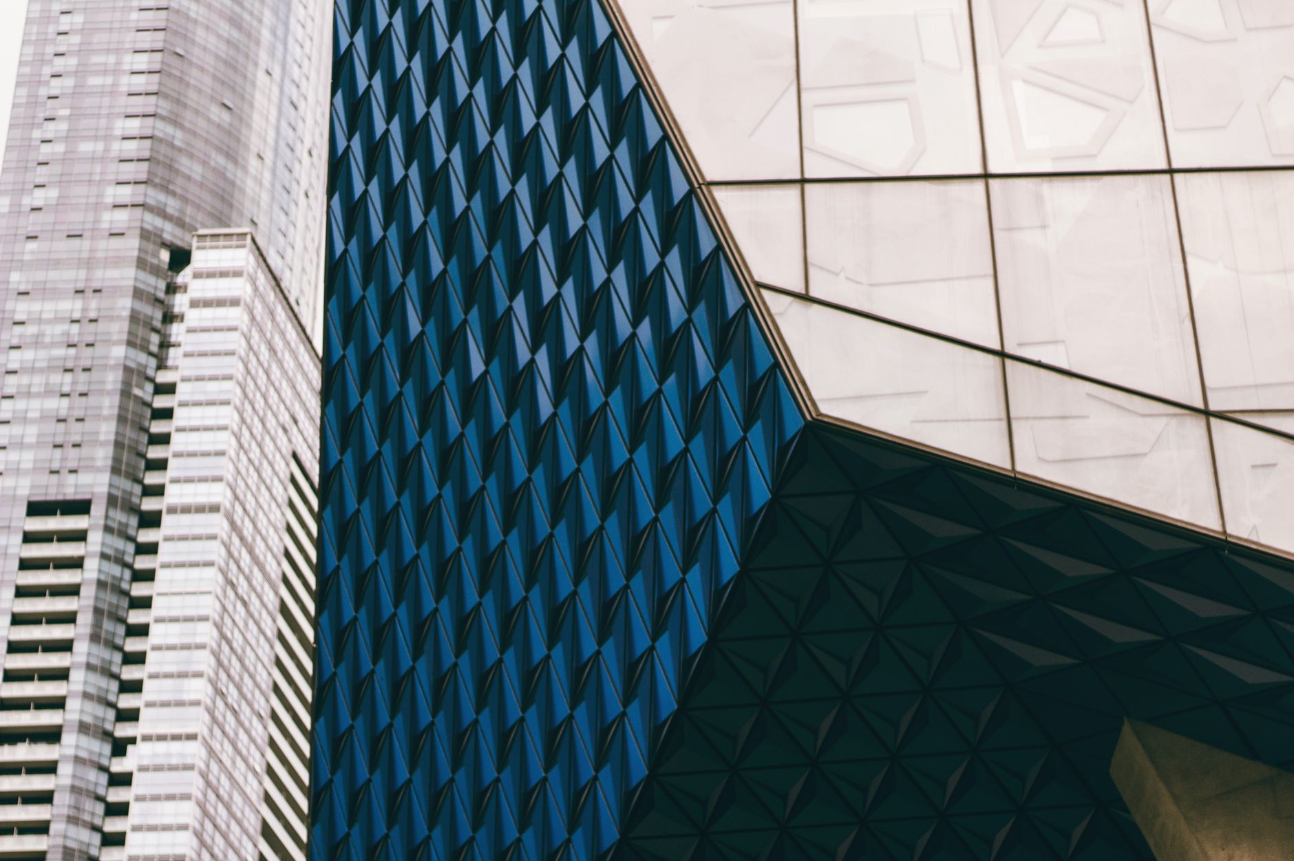 Striking modern building facade with geometric patterns in Toronto's urban setting.