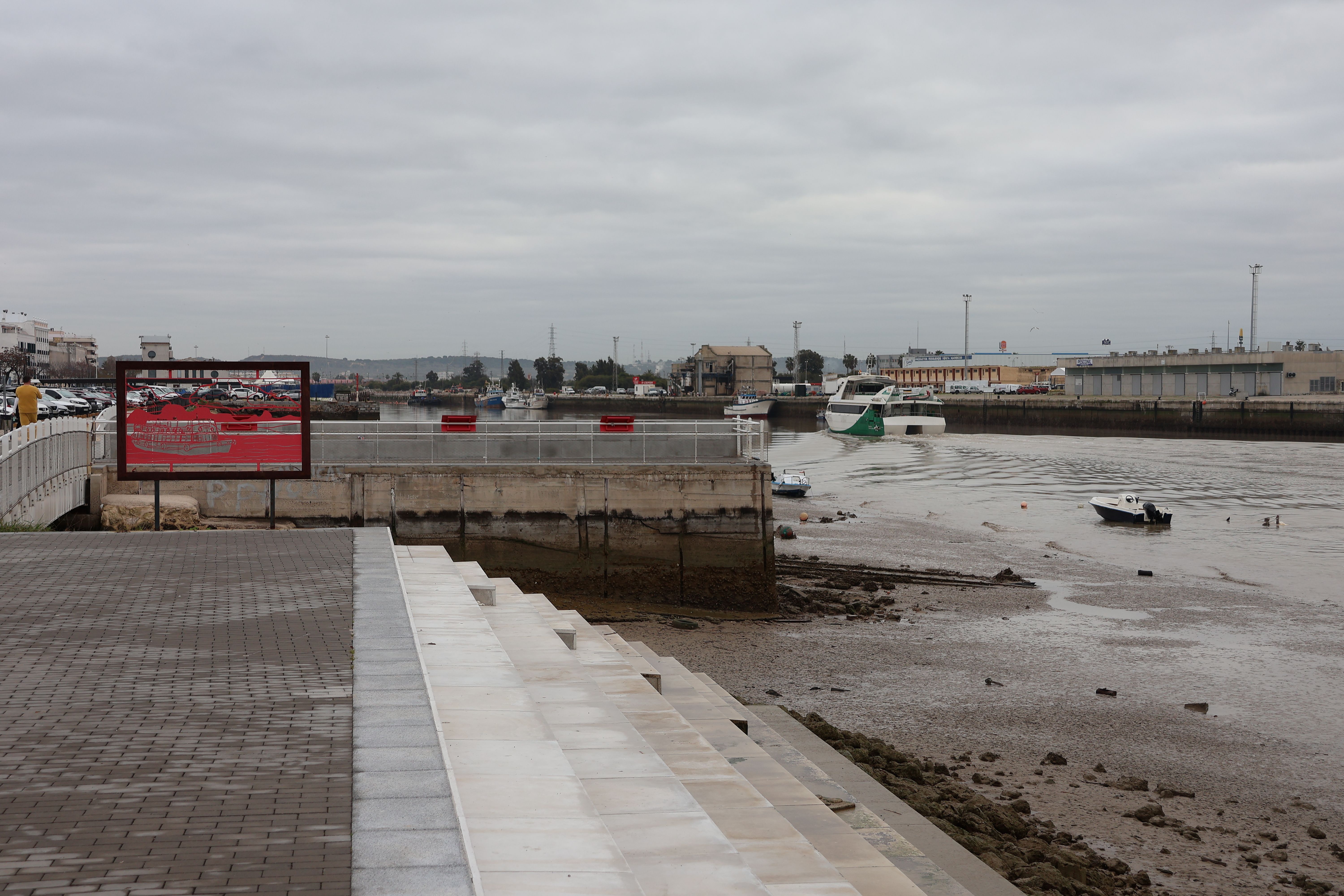 View of the riverbank and boats in El Puerto de Santa María, Spain.