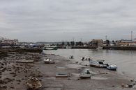 Riverbank with boats at low tide in El Puerto de Santa María, Spain.