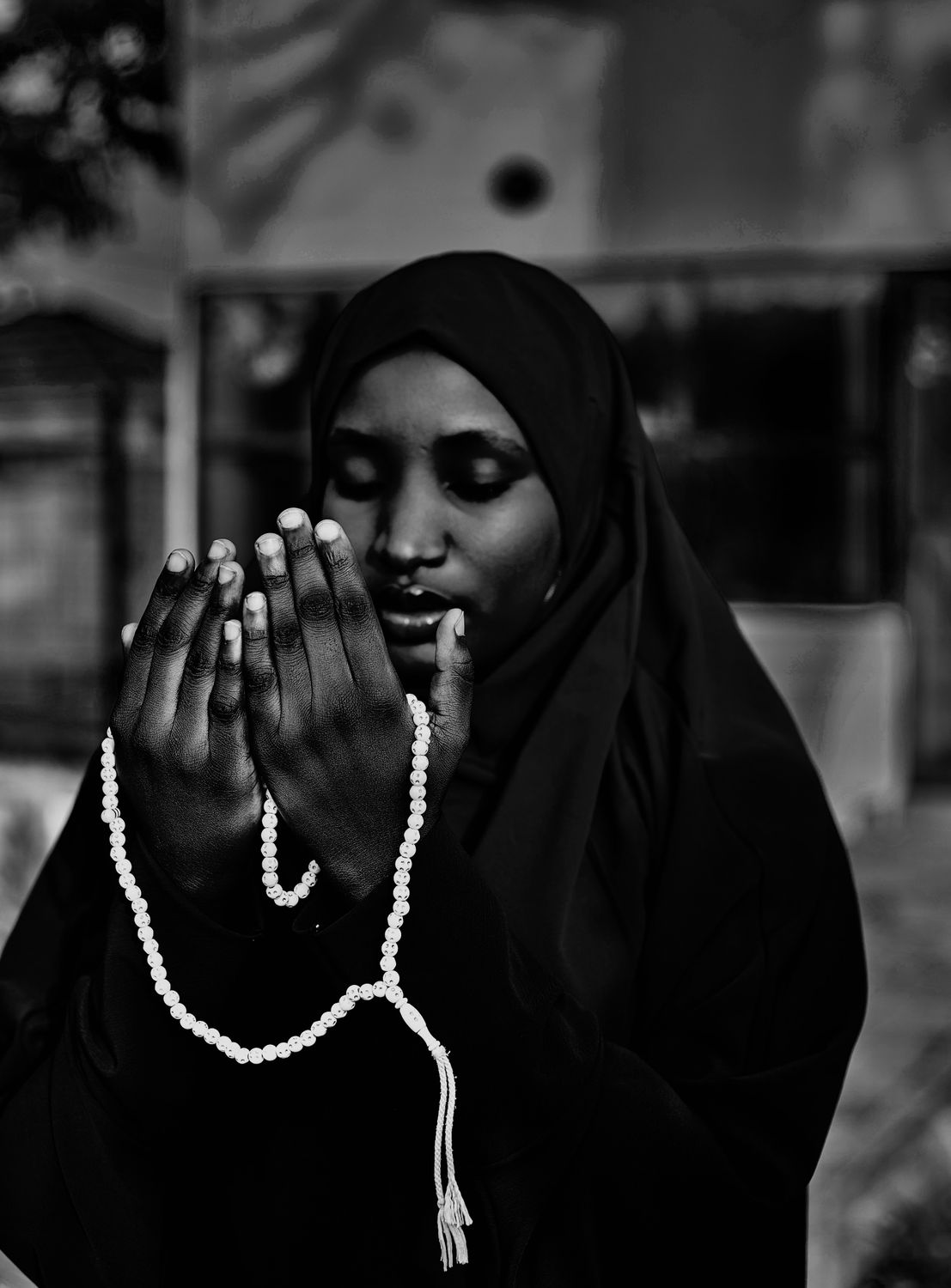 Contemplative Woman Holding Prayer Beads · Free Stock Photo