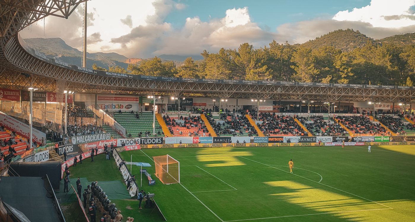 Packed soccer stadium at sunset during a World Cup match