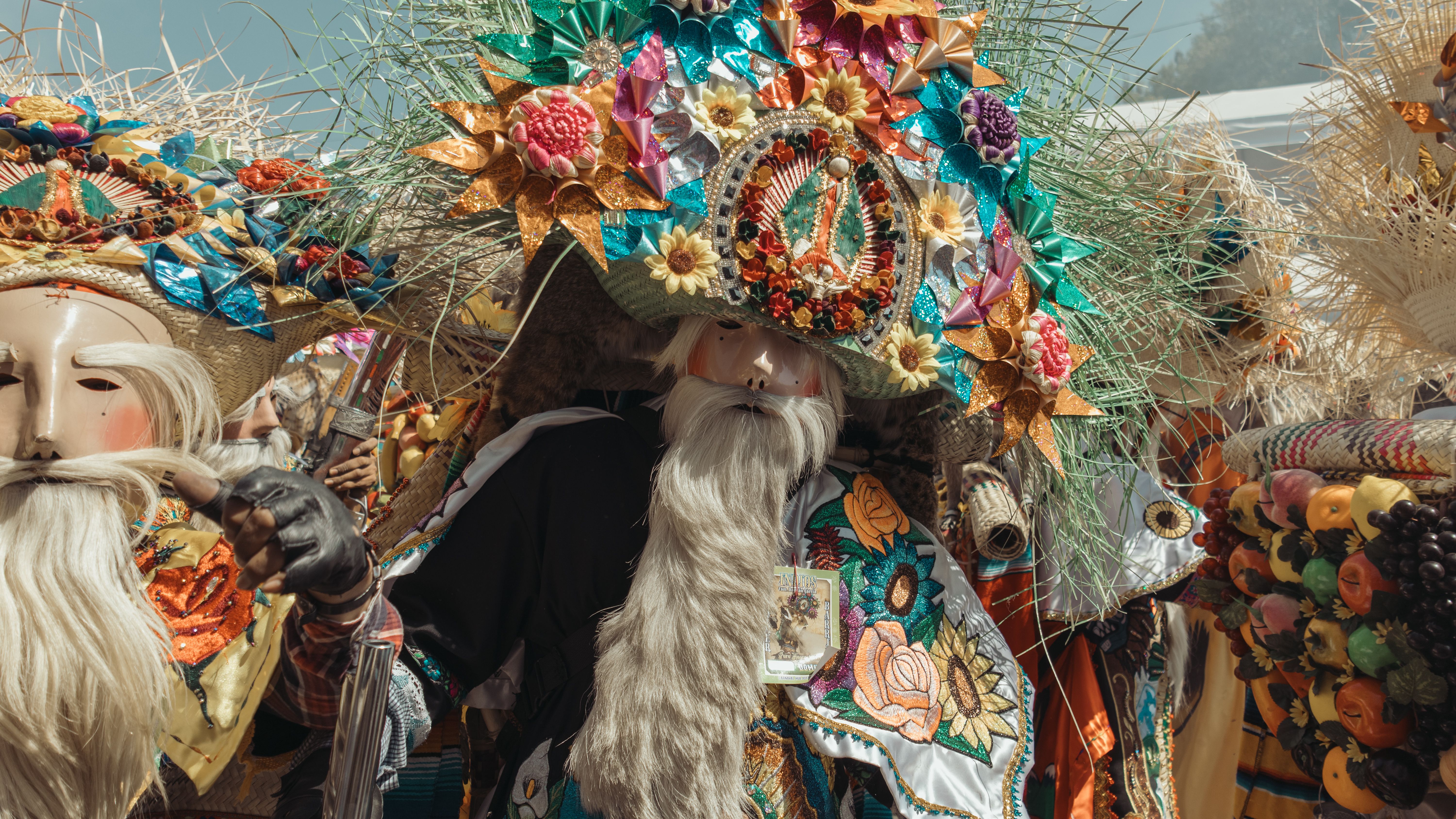 Colorful costumes and masks at a traditional Mexican festival, showcasing rich culture and heritage.