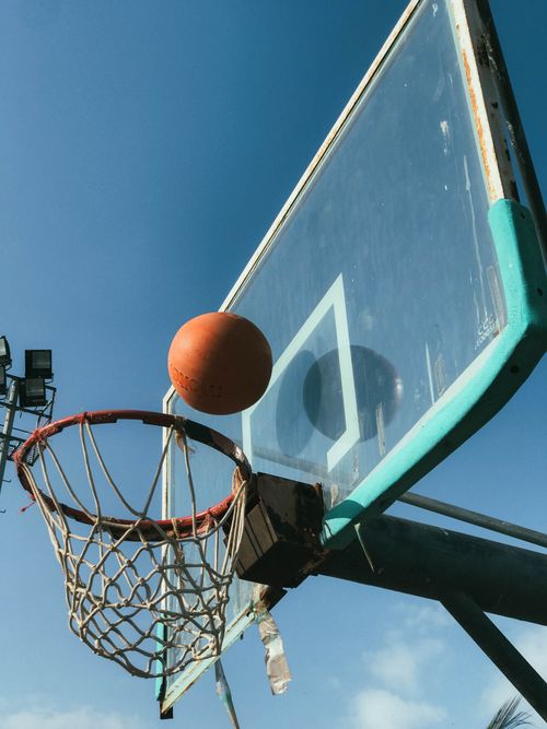 Free Dynamic shot of a basketball hoop and ball in Karachi, Pakistan, captured in bright daylight. Stock Photo