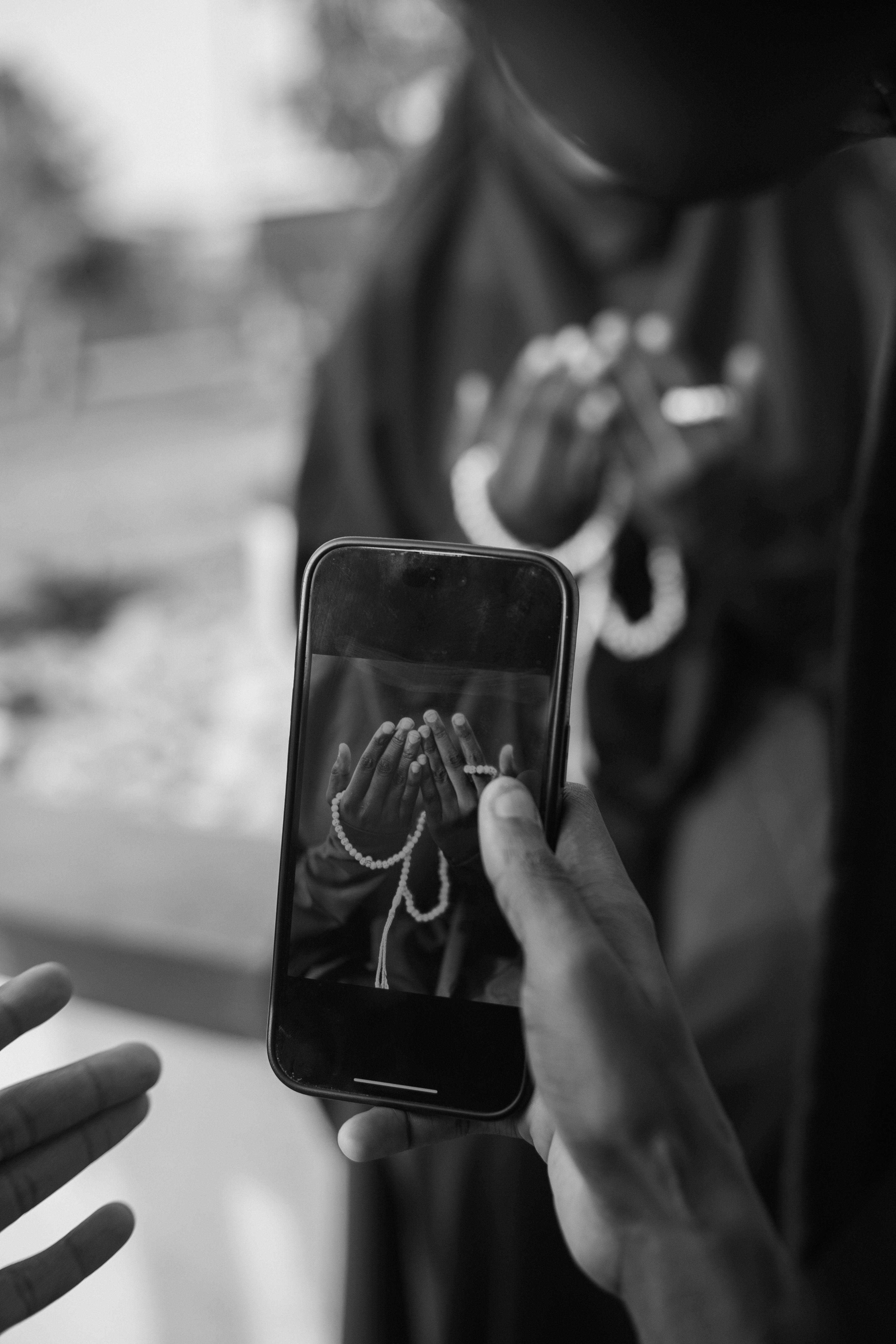 Free Monochrome image of prayer captured on a smartphone, highlighting devotion. Stock Photo