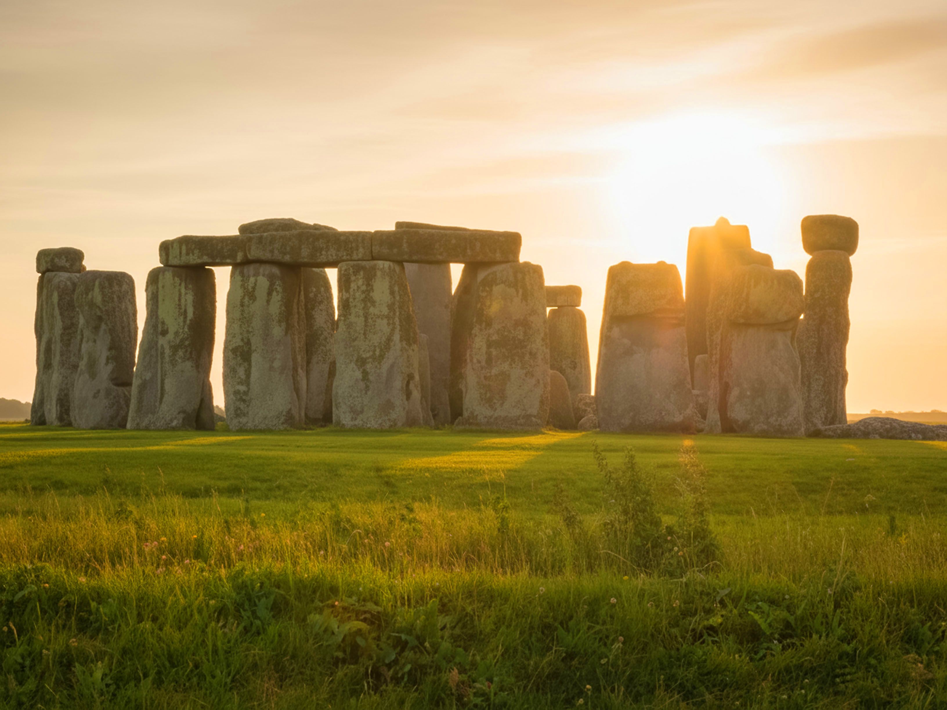 Capture of the iconic Stonehenge during sunset, highlighting its ancient structure on a serene landscape. - Cambridge