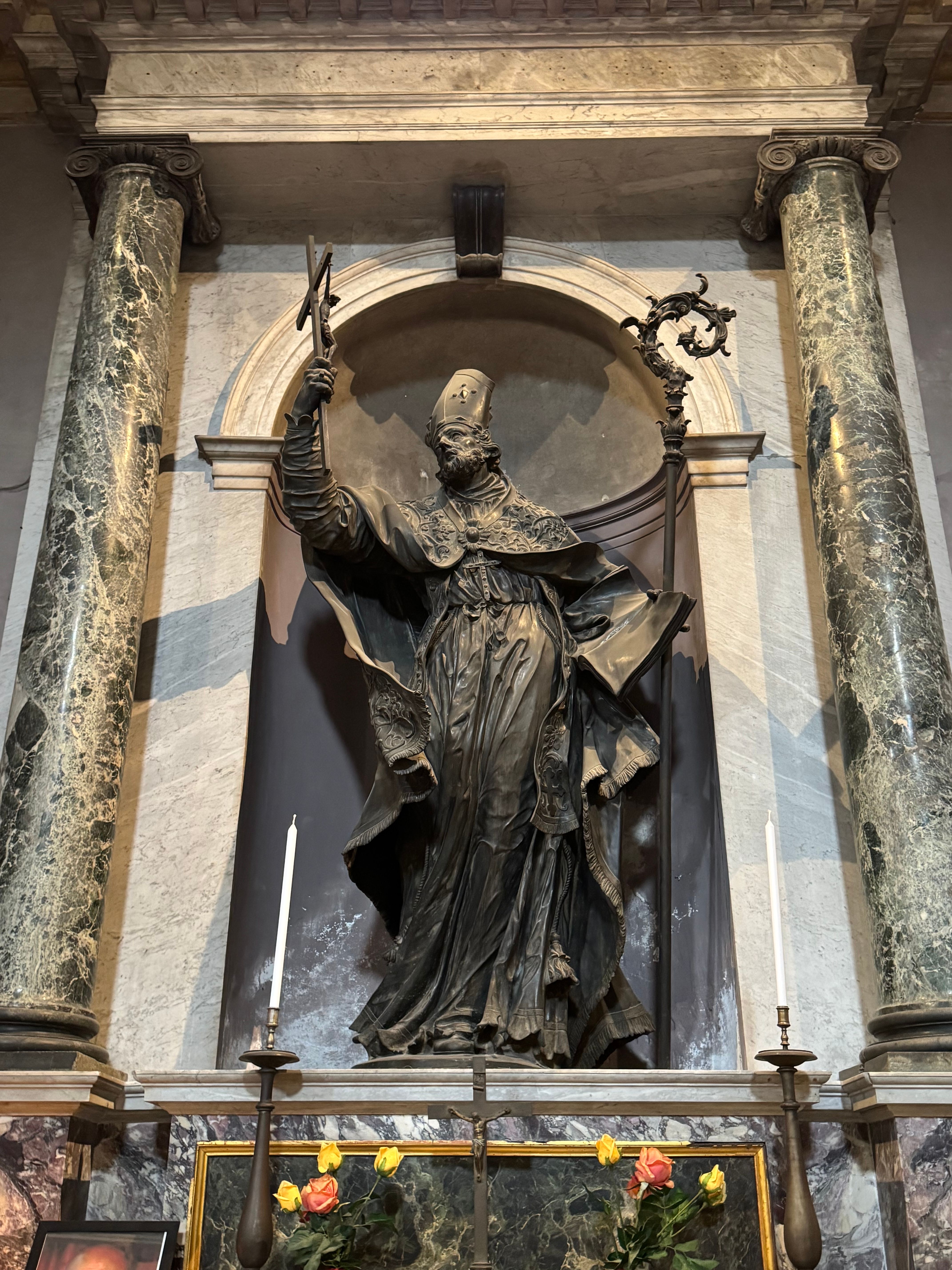Impressive statue of a saint with ornate details inside a Milanese Church.